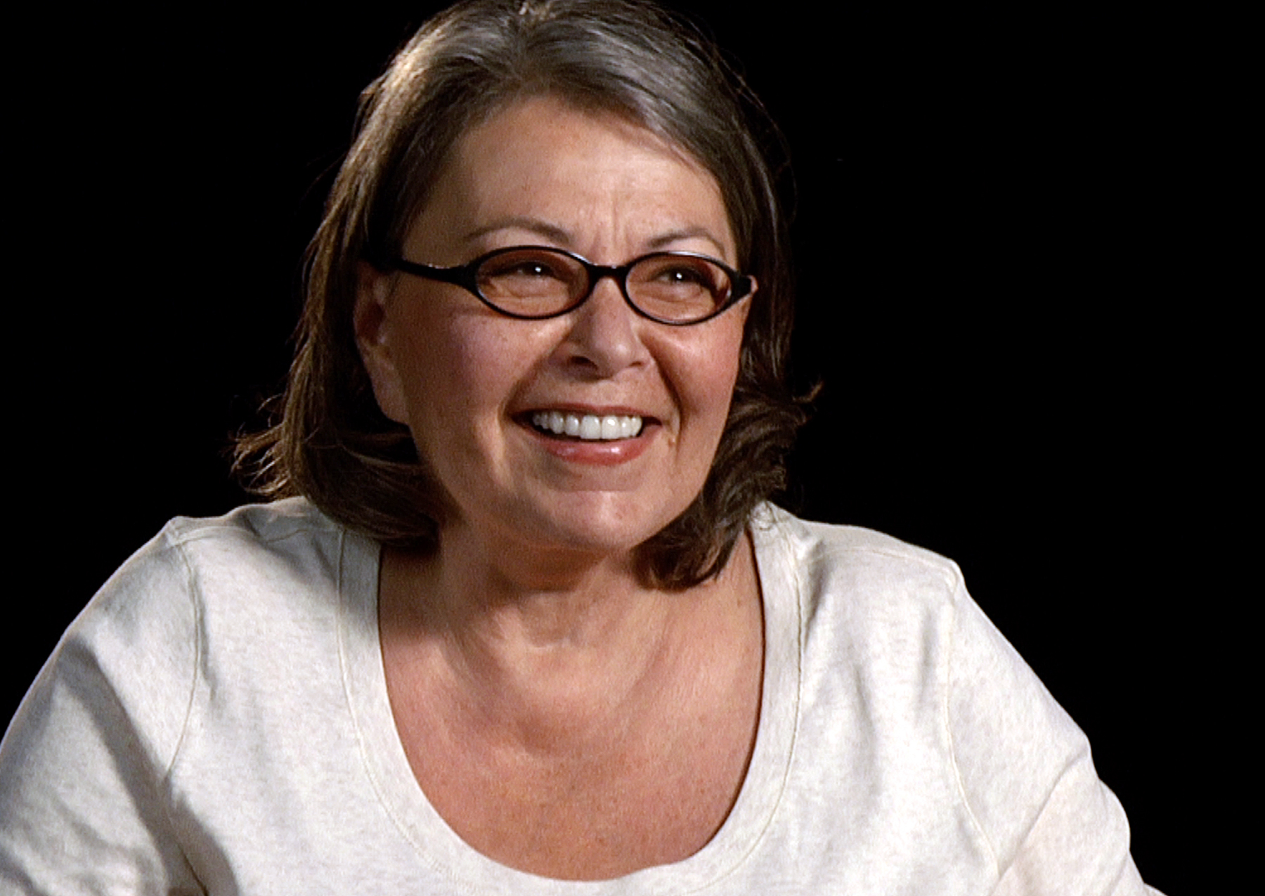 A close up photo of Roseanne Barr wearing glasses